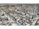 Aerial view of a snow-covered neighborhood with houses and tree-lined streets at 4820 Newton St, Denver, CO 80221