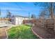 Spacious backyard with detached garage and a large grassy area at 4820 Newton St, Denver, CO 80221