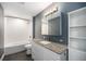 Updated bathroom with white subway tile, granite vanity, and a large mirror at 4820 Newton St, Denver, CO 80221