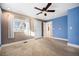 Bedroom with neutral walls, carpeting, ceiling fan and door to kitchen at 4820 Newton St, Denver, CO 80221