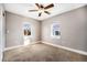 Bright bedroom with neutral walls, carpet flooring, and ceiling fan at 4820 Newton St, Denver, CO 80221