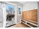 Inviting entryway with built-in bench, wood-paneled accent wall, and exterior access at 4820 Newton St, Denver, CO 80221