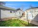 House exterior with gray siding, landscaping, and detached garage at 4820 Newton St, Denver, CO 80221