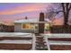 Charming ranch home with brick accents and snowy landscaping at 4820 Newton St, Denver, CO 80221