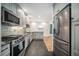 Modern kitchen with stainless steel appliances and granite countertops at 4820 Newton St, Denver, CO 80221