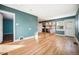 Light-filled living room featuring hardwood floors and a view of the kitchen at 4820 Newton St, Denver, CO 80221