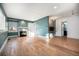 Living room with hardwood floors, fireplace, and teal walls at 4820 Newton St, Denver, CO 80221