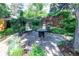 This home features a backyard entertaining area with a stone patio, seating, and beautiful landscaping at 1661 Oneida St, Denver, CO 80220