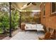 Inviting covered patio featuring a comfortable seating area and serene water feature at 1661 Oneida St, Denver, CO 80220