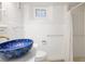 Stylish bathroom featuring white tile, gold fixtures, and a statement mosaic vessel sink at 1661 Oneida St, Denver, CO 80220