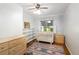 Cozy Bedroom with light wood floors, a crib, shelving, and natural light from the window at 1661 Oneida St, Denver, CO 80220