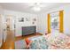 Cozy bedroom with natural light, a ceiling fan, wood floors, and colorful accent pieces at 1661 Oneida St, Denver, CO 80220