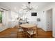 Bright dining room featuring hardwood floors, a modern chandelier, and an open view of the kitchen at 1661 Oneida St, Denver, CO 80220