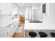 Spacious updated kitchen with white cabinets, stainless steel appliances, and a large island at 1661 Oneida St, Denver, CO 80220