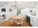 Eat-in kitchen featuring a modern light fixture and hardwood floors at 1661 Oneida St, Denver, CO 80220
