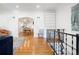 Open-concept living room with hardwood floors, white walls, and an arched entryway to the kitchen at 1661 Oneida St, Denver, CO 80220