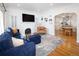 Open-concept living room with hardwood floors and a seamless flow into the dining and kitchen area at 1661 Oneida St, Denver, CO 80220