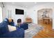 Bright living room with hardwood floors and open access to the kitchen and dining area at 1661 Oneida St, Denver, CO 80220