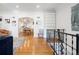 Open-concept living room with hardwood floors, white walls, and an arched entryway to the kitchen at 1661 Oneida St, Denver, CO 80220