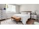 Comfortable bedroom with neutral tones, hardwood floors, and ample natural light from a large window at 551 S Main St, Byers, CO 80103