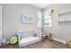 Well-lit Bedroom featuring a white crib, playful decor, and a view to the outdoors at 551 S Main St, Byers, CO 80103