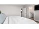 Serene bedroom showcasing a comfortable bed, neutral color palette, and a view into the ensuite bathroom at 551 S Main St, Byers, CO 80103