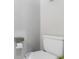 A standard toilet with toilet paper dispenser in a clean and simple bathroom at 551 S Main St, Byers, CO 80103