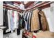 Spacious walk-in closet with organized shelving, hanging racks, and ample storage for clothing and accessories at 551 S Main St, Byers, CO 80103