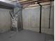 Unfinished basement with painted concrete walls and floor ready for your creative design and customization at 8160 S Fillmore Cir, Centennial, CO 80122