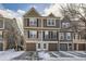 Two-story townhome with attached garage and snow-covered driveway at 8160 S Fillmore Cir, Centennial, CO 80122