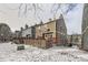 Townhouses with wood siding, decks, and fenced yards. Snow on the ground at 8160 S Fillmore Cir, Centennial, CO 80122