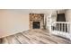 Living room with stone fireplace and wood-look flooring at 8160 S Fillmore Cir, Centennial, CO 80122