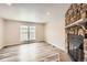 Spacious living room featuring a stone fireplace and large window at 8160 S Fillmore Cir, Centennial, CO 80122