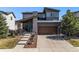 Charming two-story home featuring a covered front porch and a two-car garage at 10796 Truckee Cir, Commerce City, CO 80022