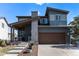 Charming two-story home featuring a covered front porch and a two-car garage at 10796 Truckee Cir, Commerce City, CO 80022