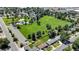 Aerial view showcasing a residential neighborhood with neat rows of homes, lush greenery, and park nearby at 1115 W Quincy Ave, Englewood, CO 80110
