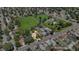 Aerial view of a single story house situated in a neighborhood with a verdant park and tree lined streets at 1115 W Quincy Ave, Englewood, CO 80110