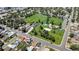 Neighborhood aerial view showcasing a green park close to residential houses along with nearby streets and trees at 1115 W Quincy Ave, Englewood, CO 80110