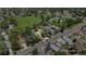 Neighborhood aerial shot showcasing a single story home and park nearby lush streets, trees, and sidewalks at 1115 W Quincy Ave, Englewood, CO 80110