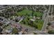 Neighborhood aerial view showcasing a green park close to residential houses along with nearby streets and trees at 1115 W Quincy Ave, Englewood, CO 80110