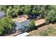 Aerial view of property featuring spacious backyard with mature trees and outbuildings at 1115 W Quincy Ave, Englewood, CO 80110