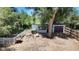 Aerial view of backyard featuring detached garage and patio surrounded by mature shade trees at 1115 W Quincy Ave, Englewood, CO 80110