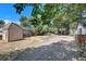 Spacious backyard featuring a storage shed and lush trees, offering a peaceful outdoor space at 1115 W Quincy Ave, Englewood, CO 80110