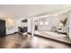 Open-concept living room with wood floors that flows into the kitchen area at 1115 W Quincy Ave, Englewood, CO 80110