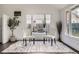 Bright seating area features hardwood floors, large windows, and comfortable chairs at 1115 W Quincy Ave, Englewood, CO 80110