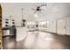 Open living space with hardwood floors, skylights, and an adjacent kitchen area at 1115 W Quincy Ave, Englewood, CO 80110