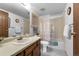 Well-lit full bathroom offers a shower-tub combo, vanity with sink, and neutral wall decor at 13902 E Marina Dr # 303, Aurora, CO 80014
