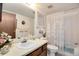 Bright bathroom features a large vanity with a framed mirror and a shower/tub combination at 13902 E Marina Dr # 303, Aurora, CO 80014