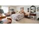 Comfortable bedroom featuring a floral comforter, neutral carpet, and a well-lit space at 13902 E Marina Dr # 303, Aurora, CO 80014
