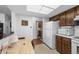 Bright kitchen showcasing wood cabinetry, white appliances, and a functional layout at 13902 E Marina Dr # 303, Aurora, CO 80014